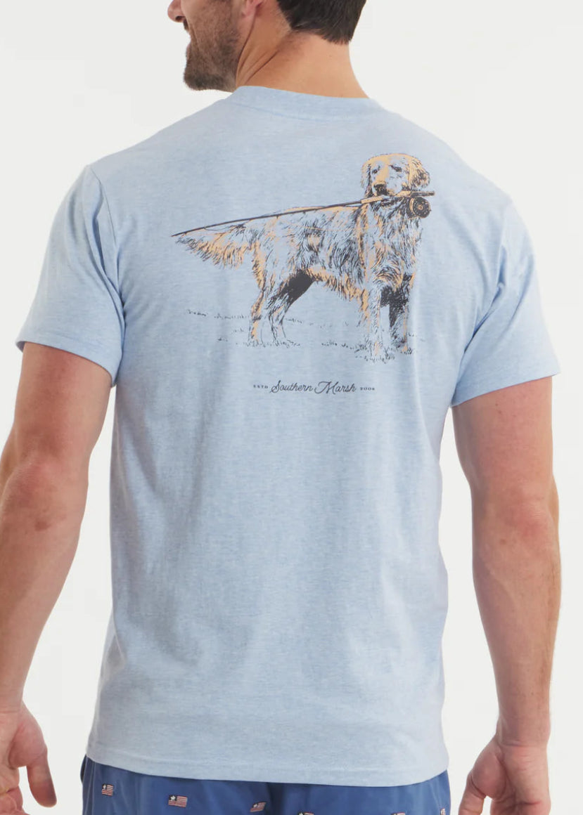 Man wearing a light blue t-shirt with a graphic of a dog and text on the back, on a plain background.