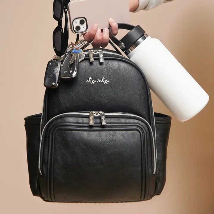 black faux leather diaper backpack Itzy Ritzy Mini Plus Diaper Bag