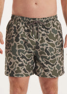 Camouflage-patterned shorts worn by a person on a plain background