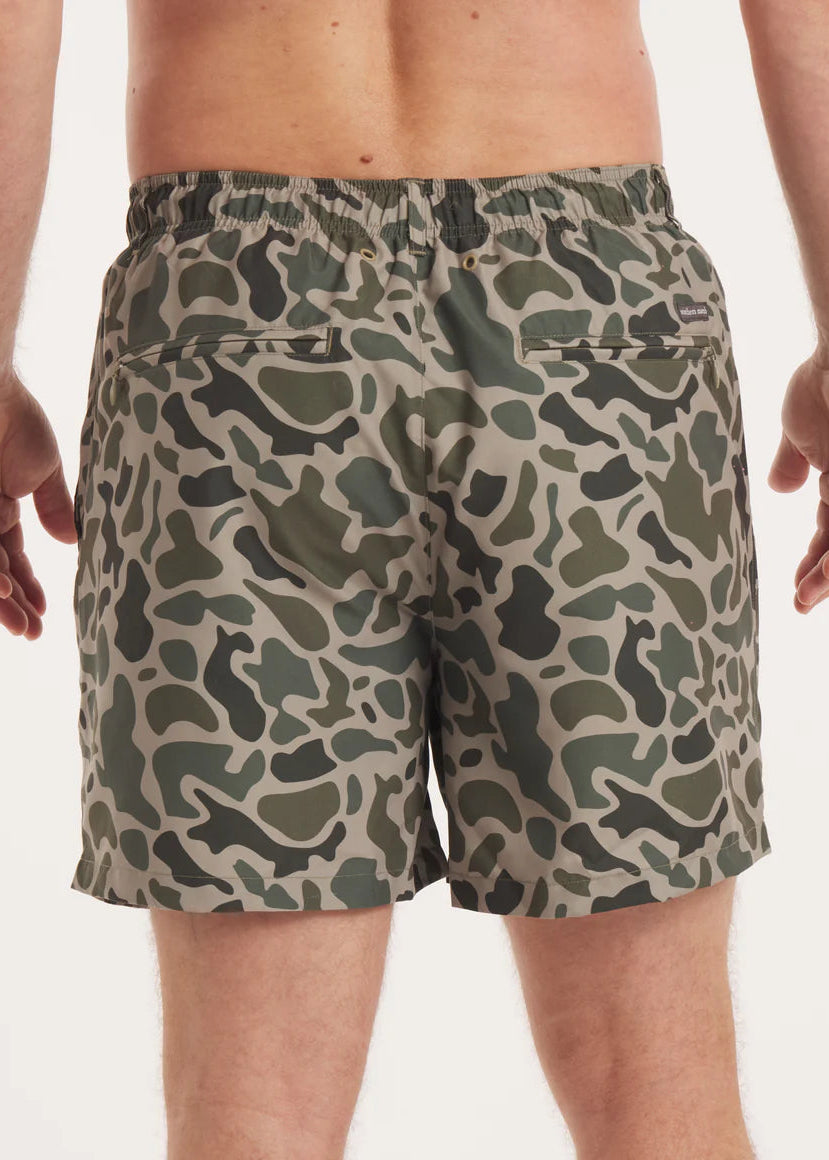 Camouflage-patterned shorts worn by a person on a white background