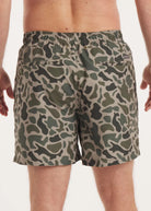 Camouflage-patterned shorts worn by a person on a white background